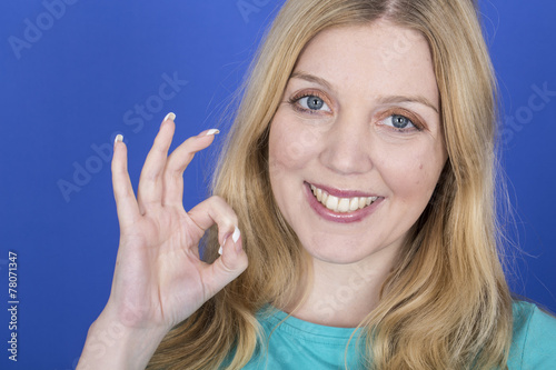 Model Released. Attractive Happy Young Woman OK Sign