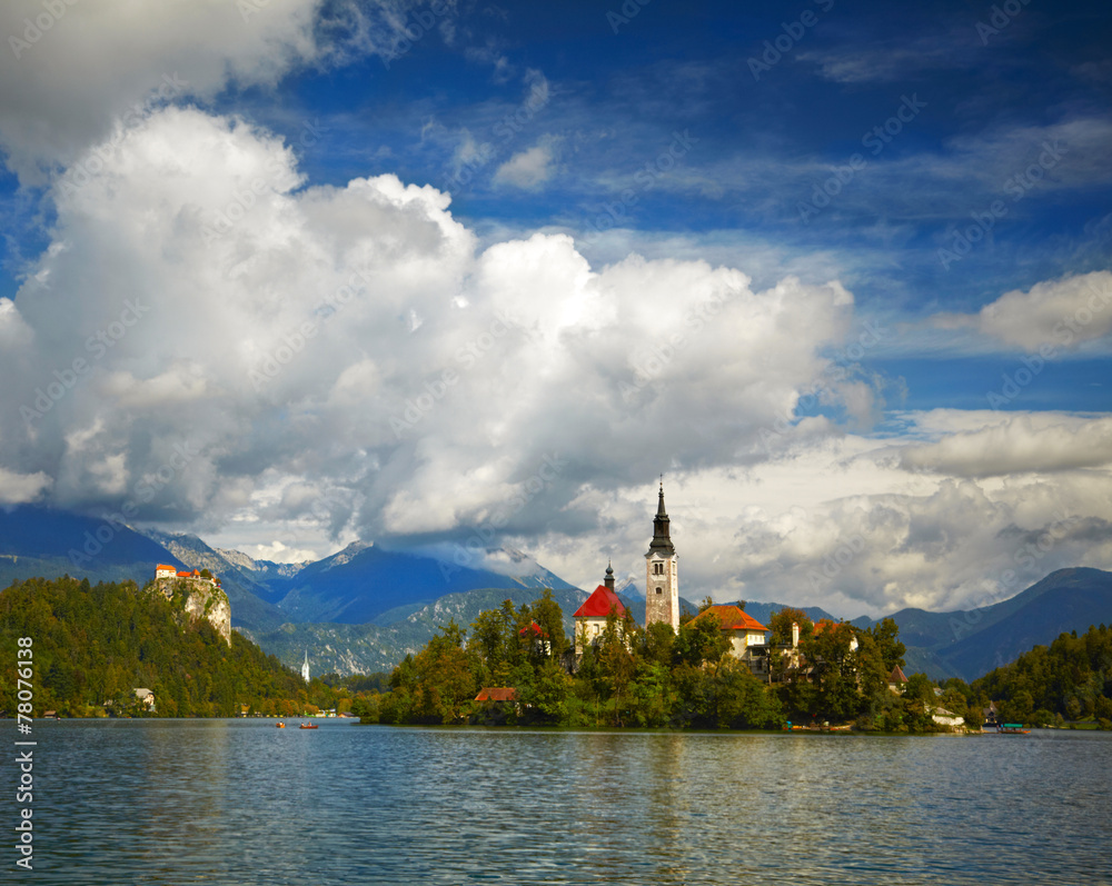 St Martin church on island and Bled lake landscape with mountain