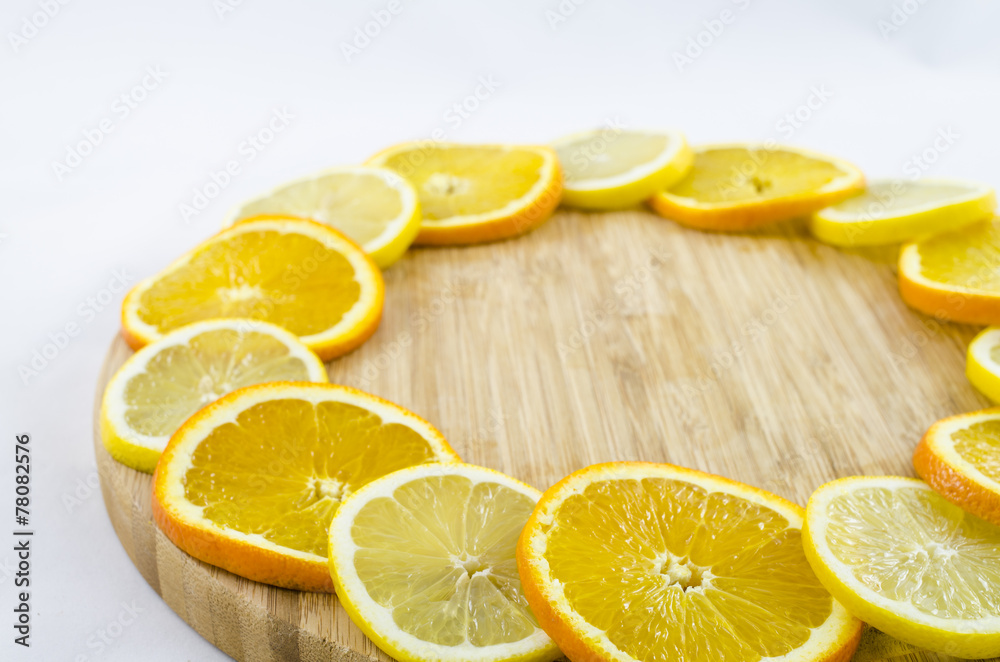 Citrus slices on wooden board. Lemon and orange. Citrus slices on wooden board. Lemon and orange.