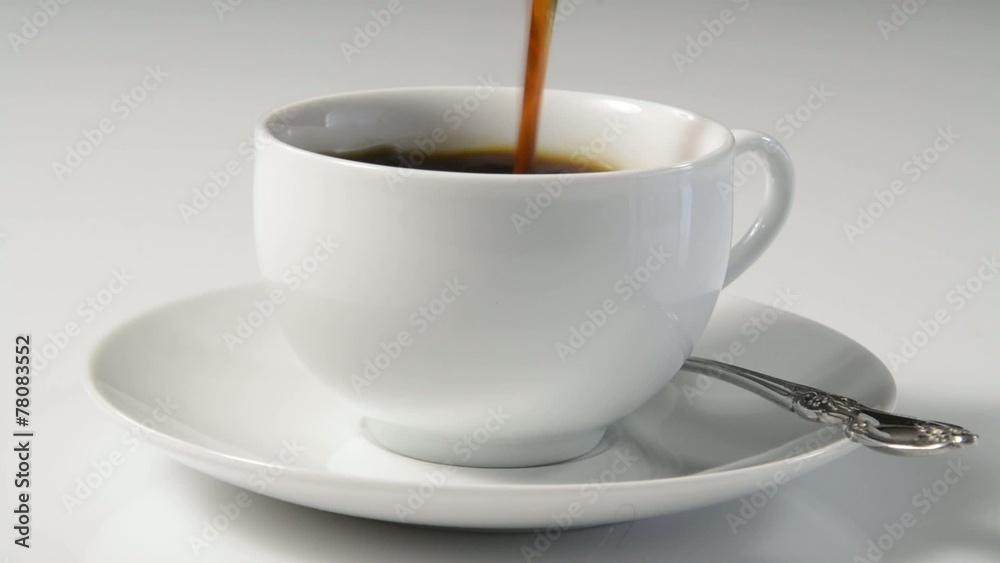 Coffee pouring into a white coffee cup Coffee pouring into a white coffee cup