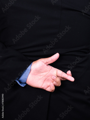 Business man lying fake hand Fingers Crossed