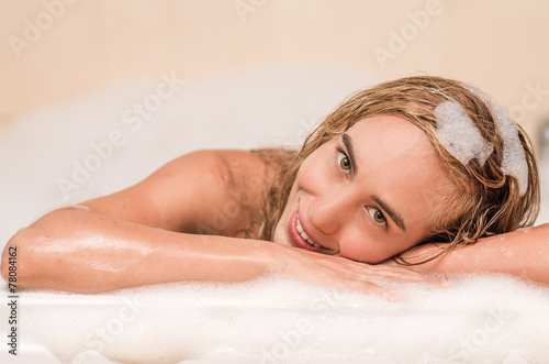 closeup of beautiful blond young woman having a bubble bath