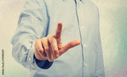 Young man pointing at a touch screen device photo