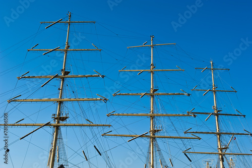 Mast of a ship on a background of blue sky.