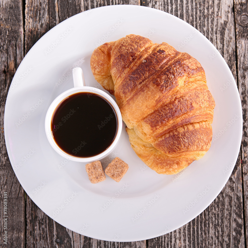fresh croissant and coffee cup