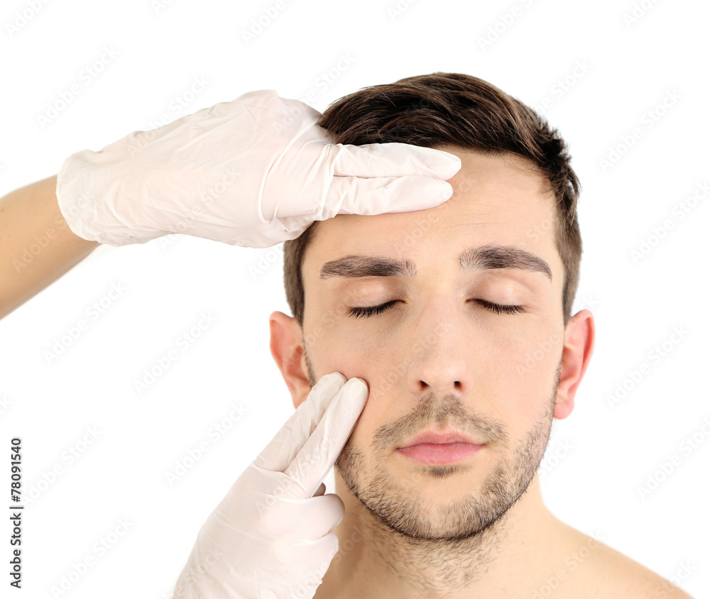 Obraz premium Doctor examines young man isolated on white