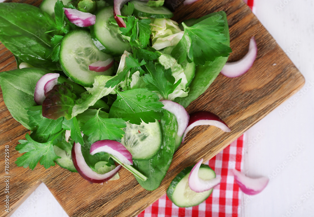 Mix salad leaves with sliced cucumber and onion Mix salad leaves with sliced cucumber and onion