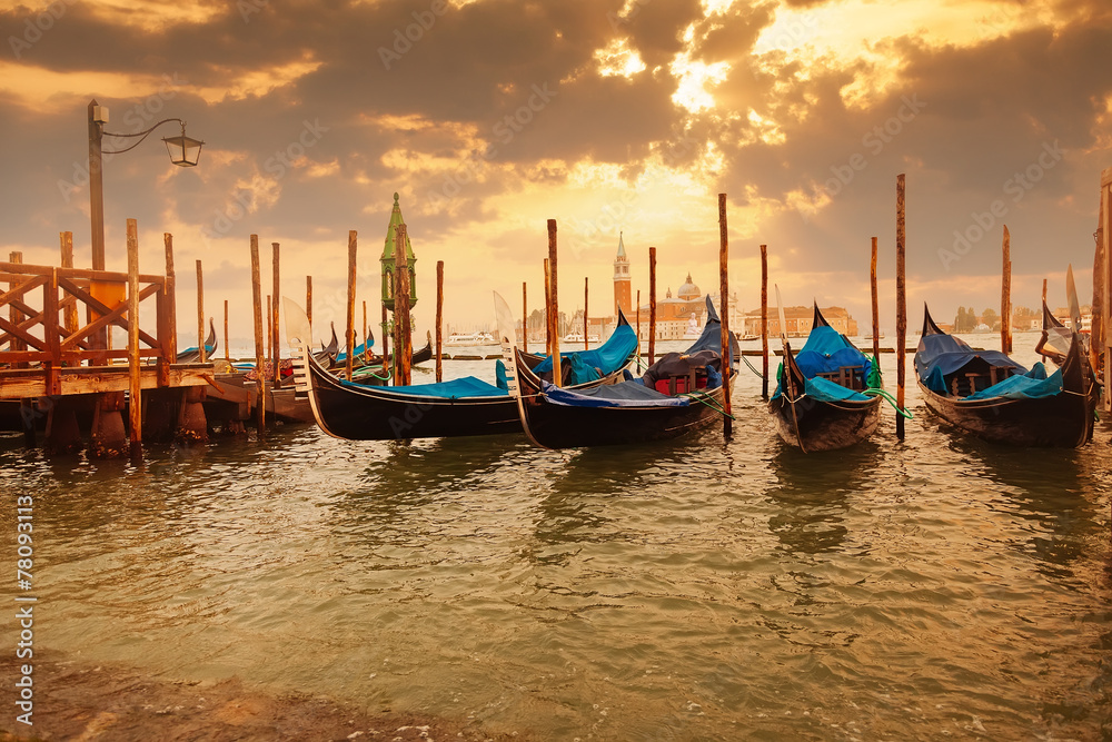 Gondolas at sunset pier near San Marco square in Venice