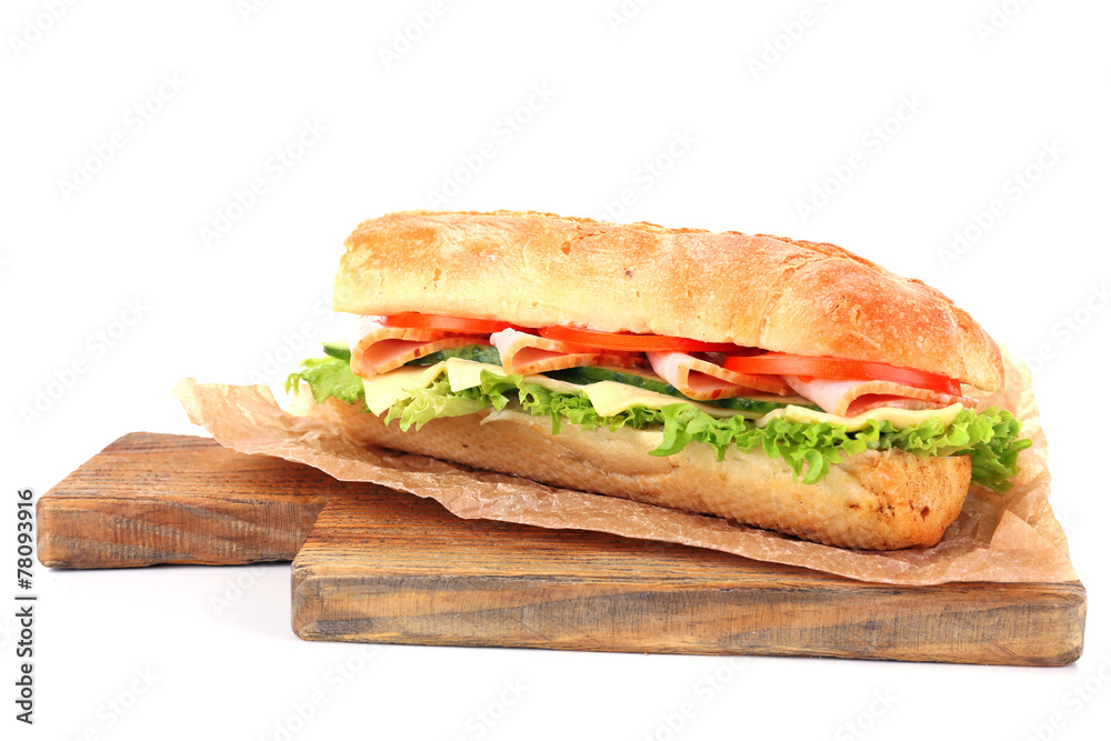 Fresh sandwich on wooden cutting board isolated on white