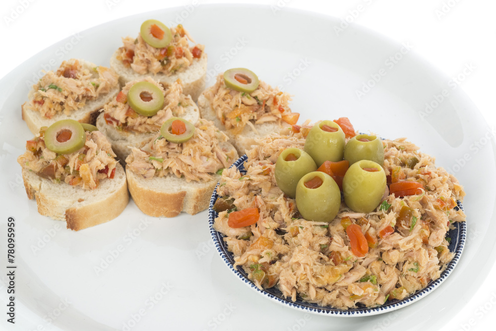 Bread with tuna salad topping on dish Bread with tuna salad topping on dish