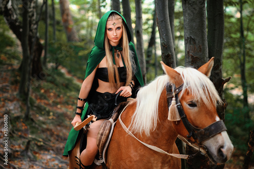 sexy girl elf with a bow on horseback
