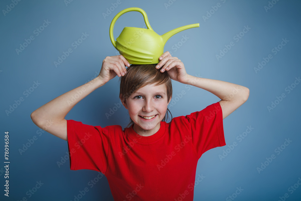 boy teenager European appearance in a red shirt yellow watering boy teenager European appearance in a red shirt yellow watering