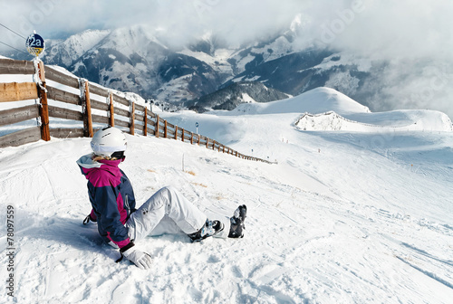 Young female skier admiring the stunning view