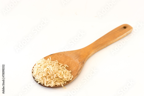 Brown Rice on Wood Ladle .