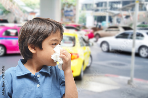 Little boy sneezing cause allergic on the road