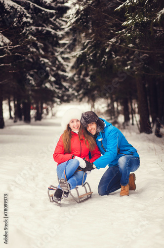 happy couple spend a fun weekend in the winter forest