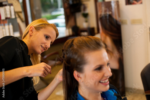 Young woman in hairdresser saloon having a treatment and haircut