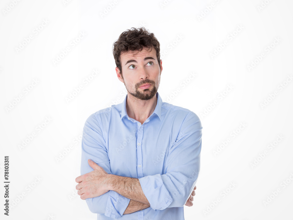 Man looking up with arms crossed Man looking up with arms crossed