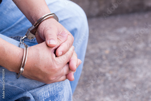 Man tied up in handcuffs photo