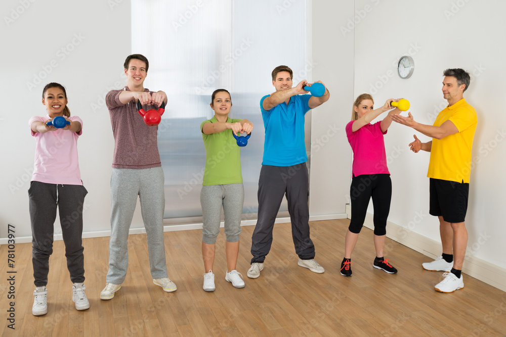 Fototapeta premium Fitness Instructor With People Exercising