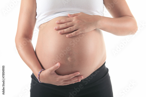 Photo of a pregnant woman over studio white background © Louis-Photo