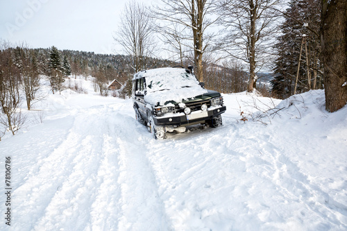Offroad car on the snow in the mountains