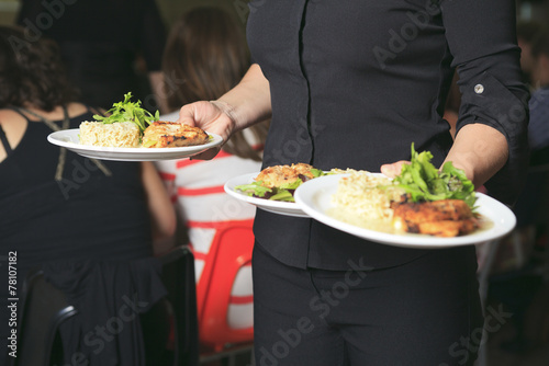 A Young waitress with plate on his hand © Louis-Photo