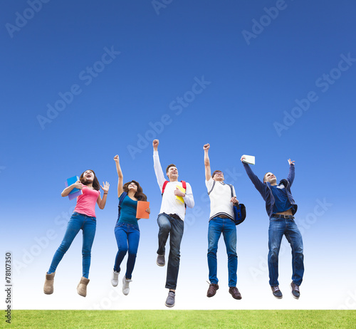 Happy young group of students jumping together