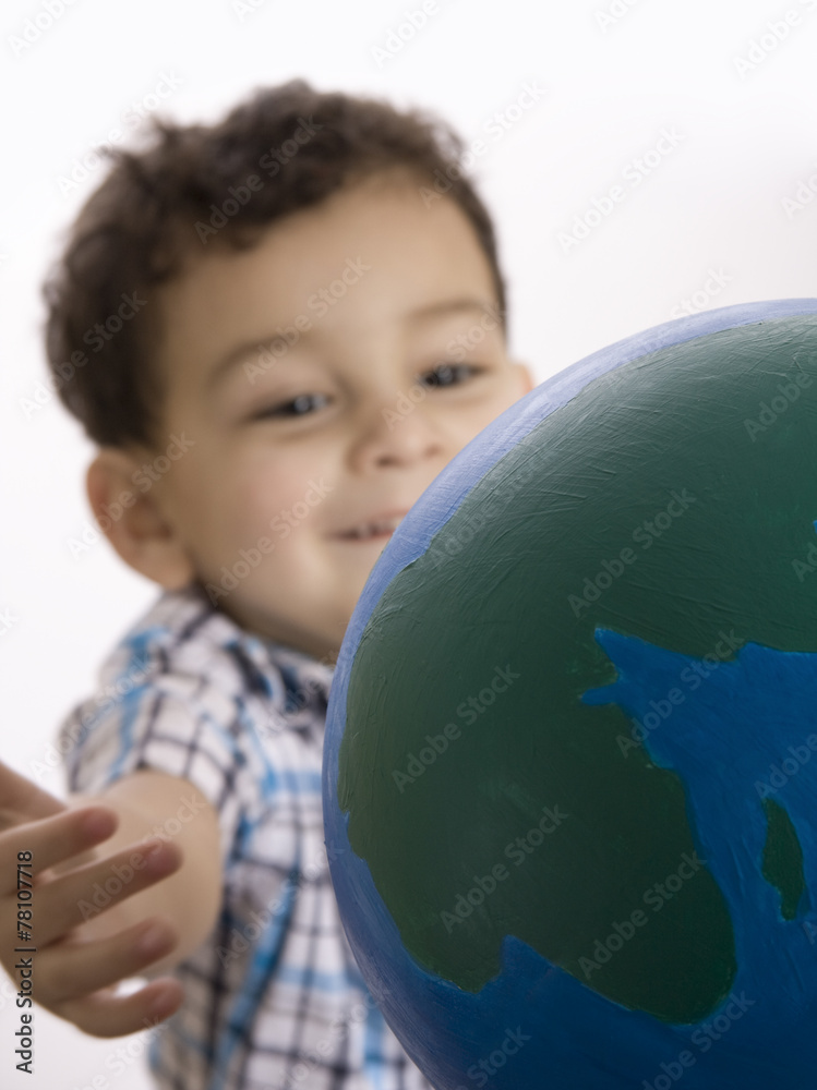 A Little boy holding the earth over white background A Little boy holding the earth over white background