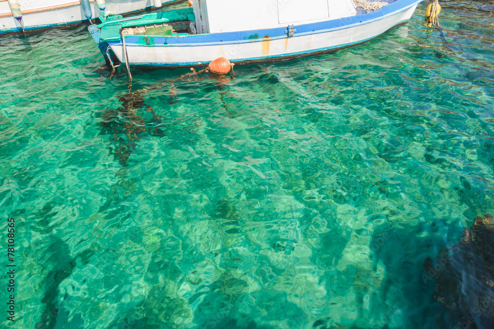 Sea boat in clear turquoise water on Greek island Kalymnos