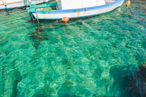 Sea boat in clear turquoise water on Greek island Kalymnos © nkarol