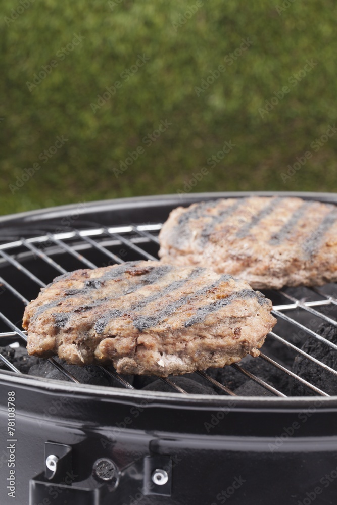 hamburgers grilling on charcoal grill Stock Photo Adobe Stock