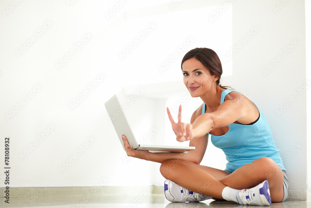 Fit woman doing the victory sign with fingers Fit woman doing the victory sign with fingers