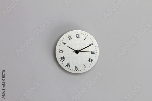 roman number clock surface on grey background