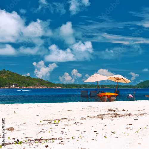 Tropical beach at Seychelles with picnic table and chairs