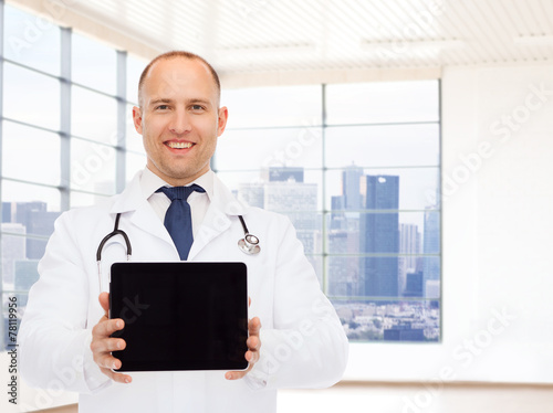 smiling male doctor with tablet pc