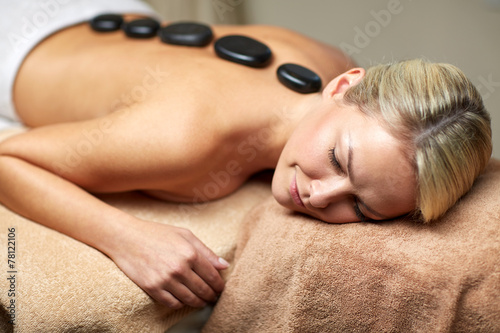 close up of woman having hot stone massage in spa