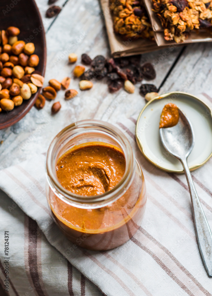 Fresh peanut butter in the pot and tea spoon, top view Fresh peanut butter in the pot and tea spoon, top view