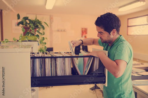 Clerk looking files at office photo