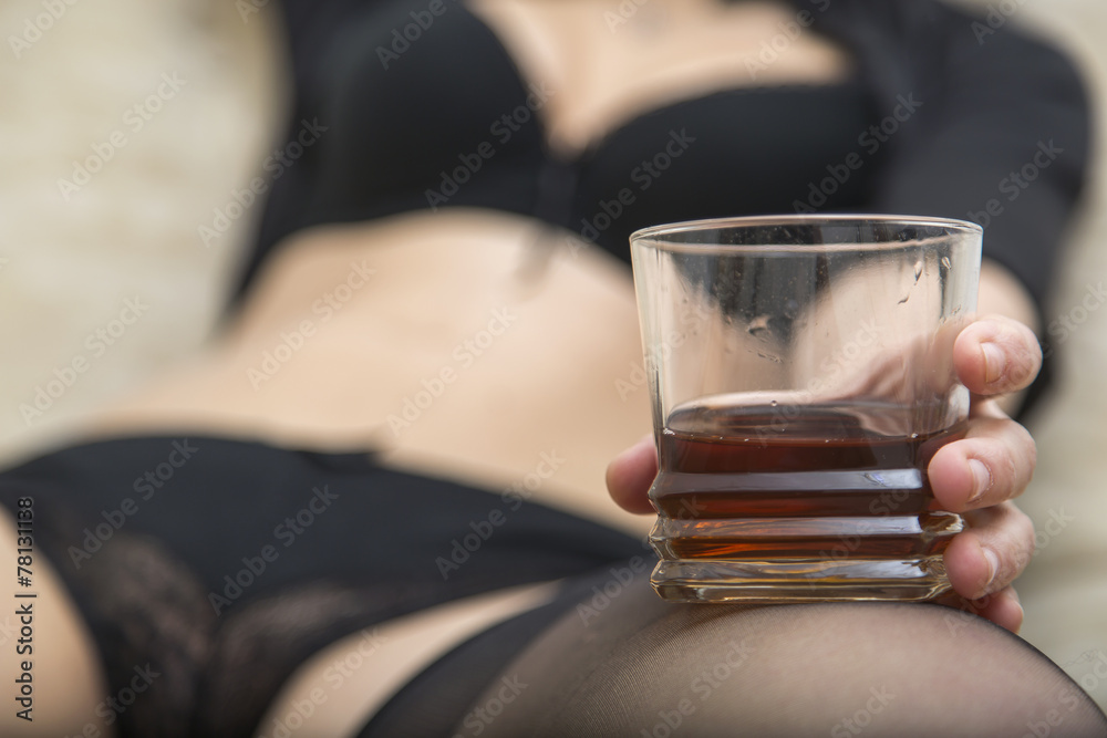 Sexy woman in black underwear holding glass of whiskey Sexy woman in black underwear holding glass of whiskey