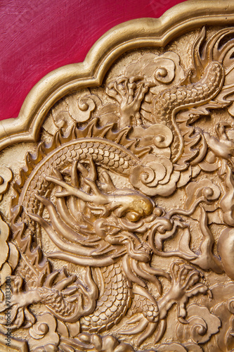 Golden dragon decorated on red wall