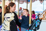Boy and Mother on Carousel Smiling at Each Other