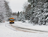 School Bus Driving Down A Snow Covered Rural Road - 1