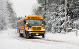 School Bus Driving in Winter on a Snow Covered Road