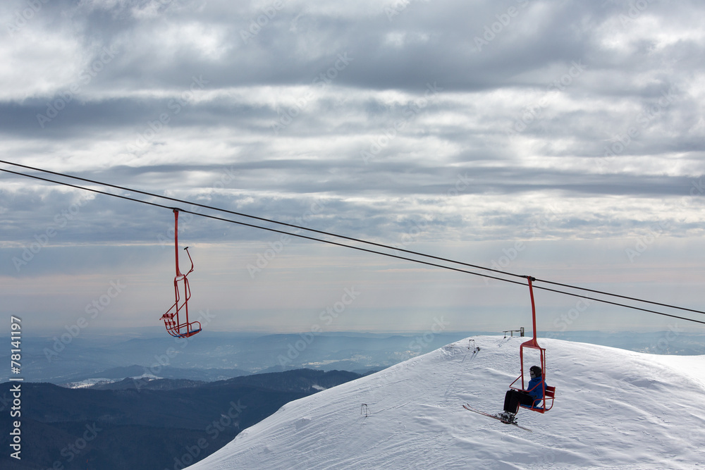 Skiers on chairlift in moutain Skiers on chairlift in moutain