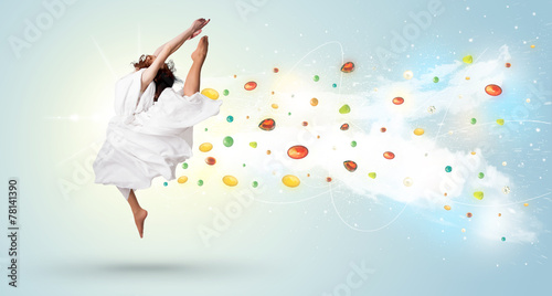 Beautiful woman jumping with colorful gems and crystals on the b