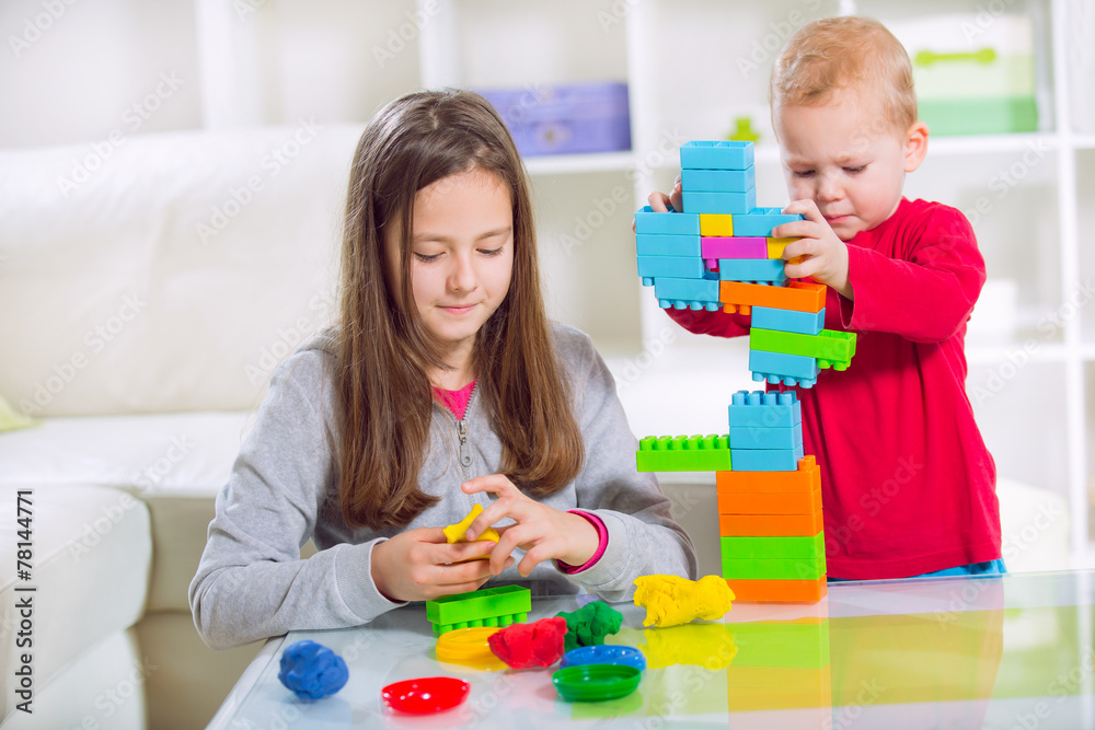Two children play with blocks