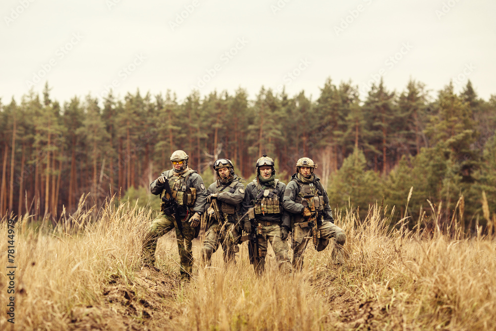 group of soldiers standing with arms and looking at the camera group of soldiers standing with arms and looking at the camera