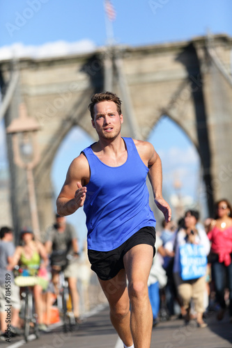 Running athlete training on Brooklyn bridge, NYC © Maridav