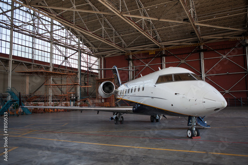 Business jet airplane stays in hangar..